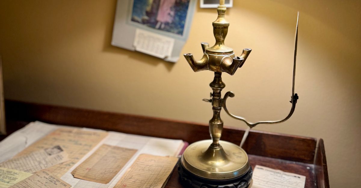 Vintage writing desk with a brass lamp, papers, and a fountain pen in warm light, representing careful legal review under an experienced lead attorney.