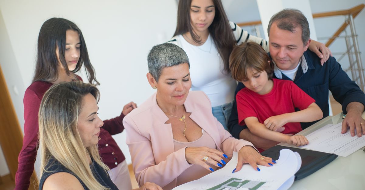 Family reviewing a home layout together, representing planning for a child’s new school, home, and daily routine after relocation.