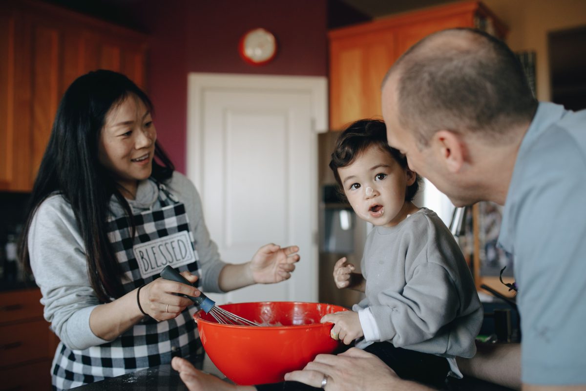 A family baking together in a warm kitchen at home